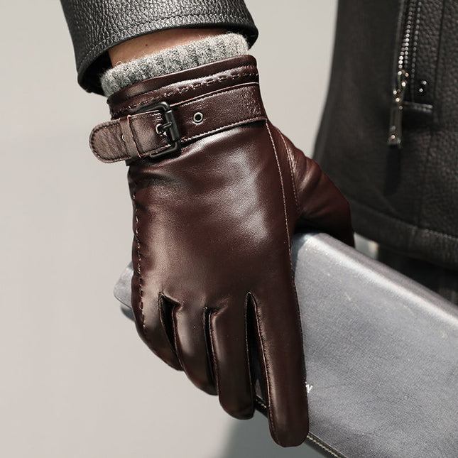 Brown leather glove with a buckle on a neutral background