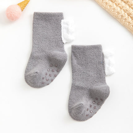 Pair of gray baby socks with non-slip dots on a white background