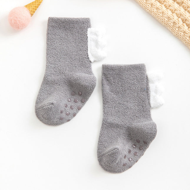 Pair of gray baby socks with non-slip dots on a white background