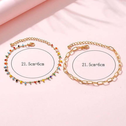 Stylish gold anklets featuring colorful beads and geometric chain design, perfect for all occasions and outfits.