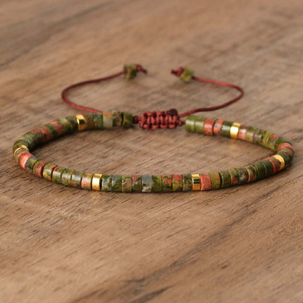Natural stone beaded bracelet with adjustable clasp, featuring earthy tones and a hand-woven design.