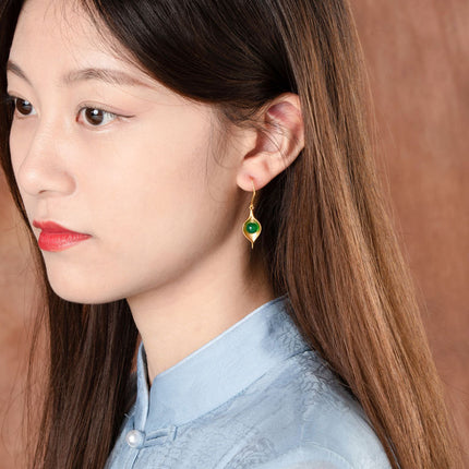 Girl wearing gold vintage earrings with cartoon and geometric designs, lightweight and elegant accessory for daily wear.