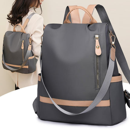 Gray backpack with beige accents on a white surface