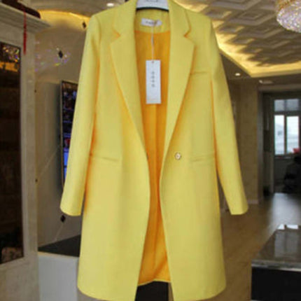 Yellow coat with a tag on a mannequin in an indoor setting