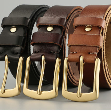 Three leather belts with gold buckles in black, brown, and tan on a gray background