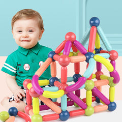Child playing with colorful magnetic building blocks