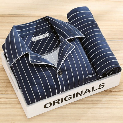 Folded navy pinstripe shirt on a white box with 'ORIGINALS' branding on a wooden surface
