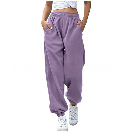 Purple sweatpants worn by a person on a white background