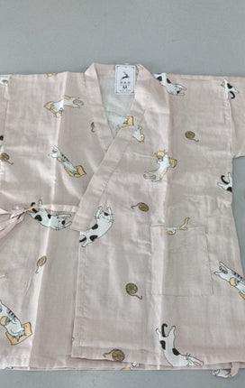 Light pink kimono with cat pattern on a gray background