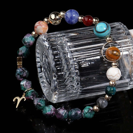 Multicolored beaded bracelet with a clear crystal container on a black background