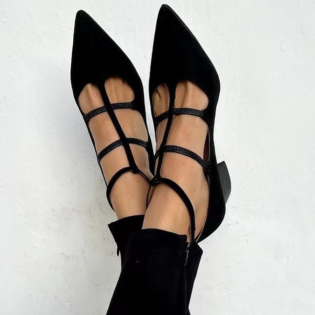 Black strappy high heels on a white background