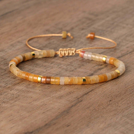 Hand-woven adjustable bracelet featuring natural stone spacer beads in warm tones.