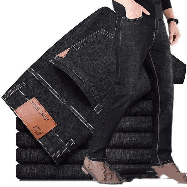 Stack of black jeans with a brand label on a white background