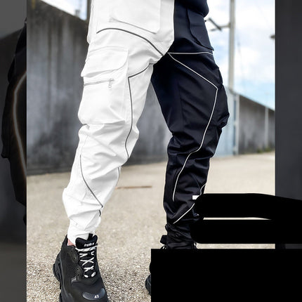 Person wearing black and white pants with a blurred background