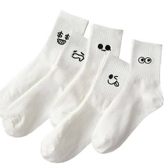 Four white socks with black smiley face designs on a white background