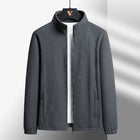 Gray jacket on a hanger against a light gray background