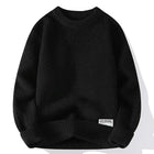 Loose black pullover sweater with textured fabric, long sleeves, and a 'New Design' label, ideal for autumn and winter fashion.
