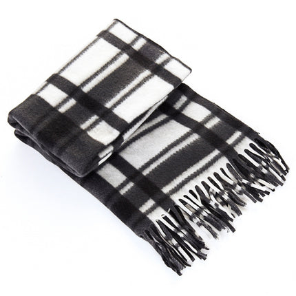 Black and white plaid blanket with fringes on a white background