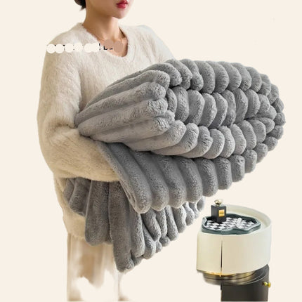 Person holding a gray plush blanket with product details on a blurred background