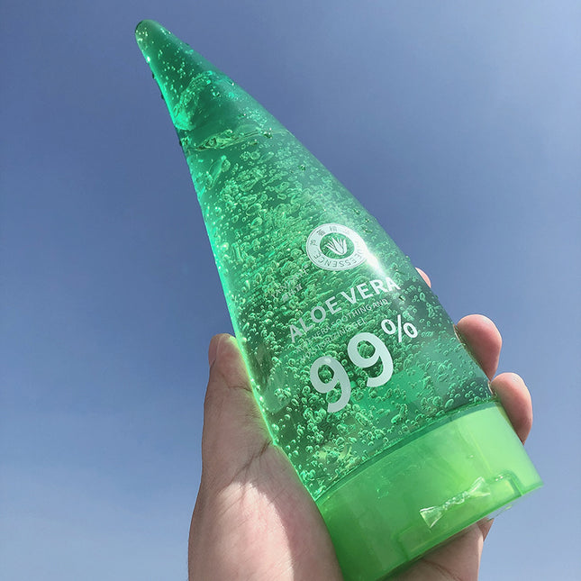 Green aloe vera gel bottle held against a blue sky