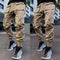 Beige cargo pants with white accents worn by a person on an urban street.