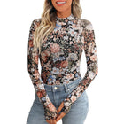 Woman wearing a floral long-sleeve top and jeans on a white background