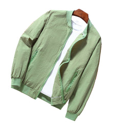 Green jacket on a wooden surface with a white shirt underneath