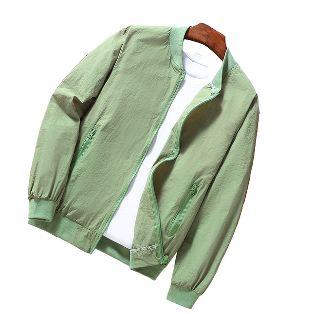 Green jacket on a wooden surface with a white shirt underneath