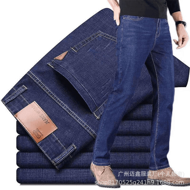 Folded blue jeans with a brand tag on a white background