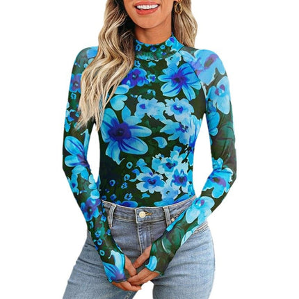 Woman wearing a floral long-sleeve top with blue flowers on a green background
