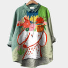 Colorful shirt with floral design on a hanger against a white background