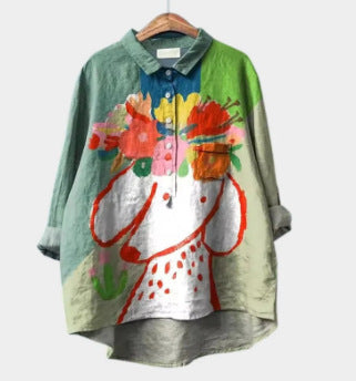 Colorful shirt with floral design on a hanger against a white background
