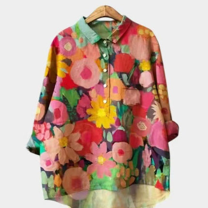 Colorful floral shirt on a hanger against a white background