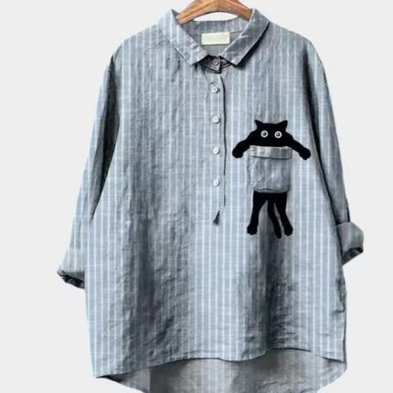 Plaid shirt with a black cat design on a hanger against a white background