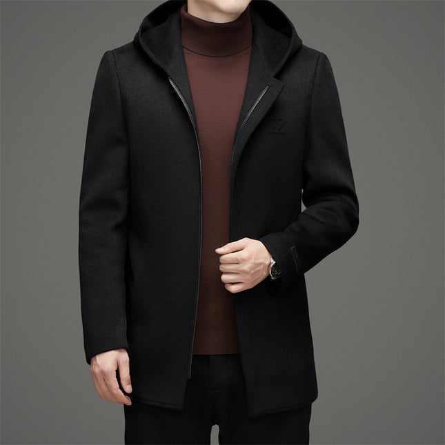 Black coat worn by a person on a gray background