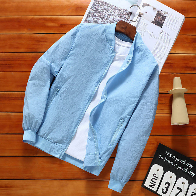 Light blue jacket on a hanger with a white shirt underneath, placed on a wooden surface with a magazine and decorative items.