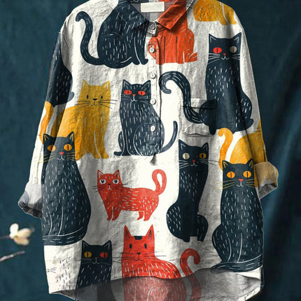 Shirt with cat pattern on a hanger against a dark background