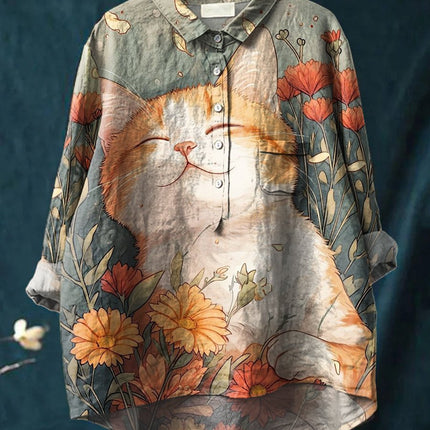 Floral and cat patterned shirt on a hanger against a dark background