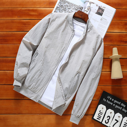 Light gray jacket on a wooden surface with a magazine underneath