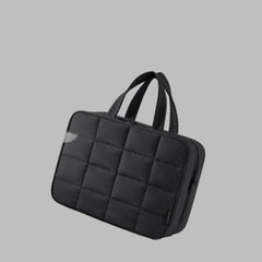 Black quilted fabric bag with text 'Soft, Lightweight Nylon Fabric' on a white background