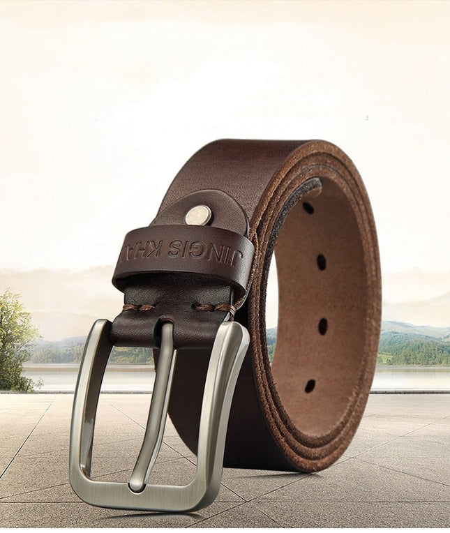 Brown leather belt with silver buckle on a blurred landscape background