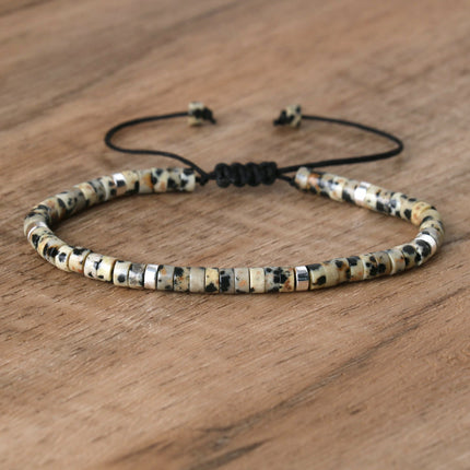 Hand-woven spacer beads bracelet with natural stones, adjustable design for women, featuring a mix of earthy tones.