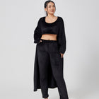 Woman wearing a black outfit on a white background