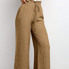 Brown pants with a drawstring waist on a light gray background