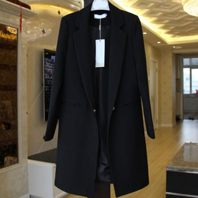Black coat on a hanger with a tag in an indoor setting