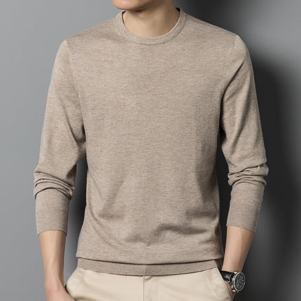 Beige sweater worn by a person against a gray background