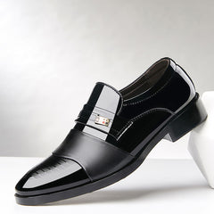 Black dress shoe with a silver buckle on a white background