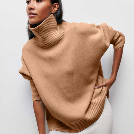 Woman wearing a beige turtleneck sweater against a white background