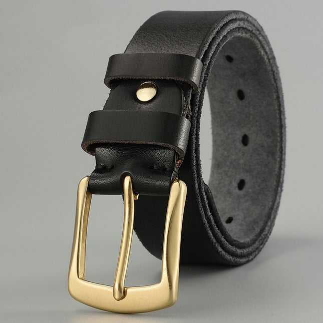 Black leather belt with a gold buckle on a gray background