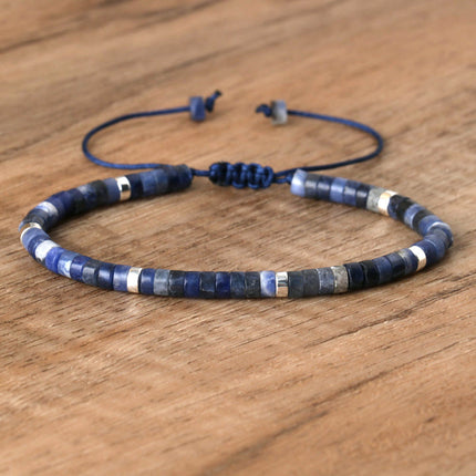Hand-woven natural stone adjustable bracelet featuring blue and silver spacer beads.